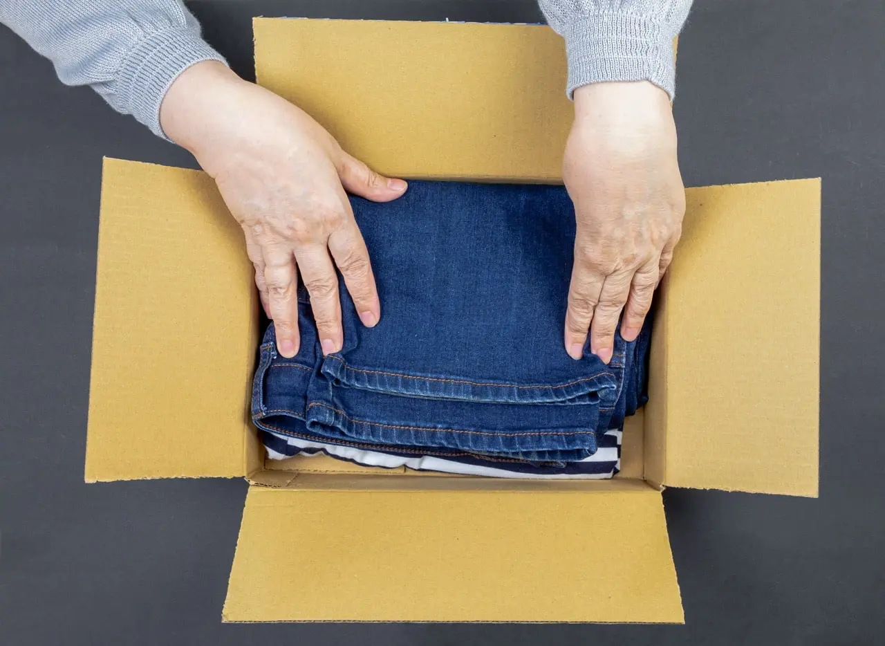 A woman packing things for an elderly loved one who will move to an assisted living facility