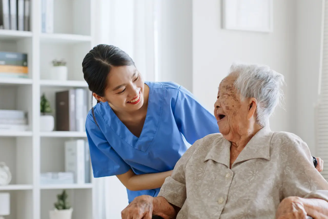 An elderly woman being cared for in an assisted living facility