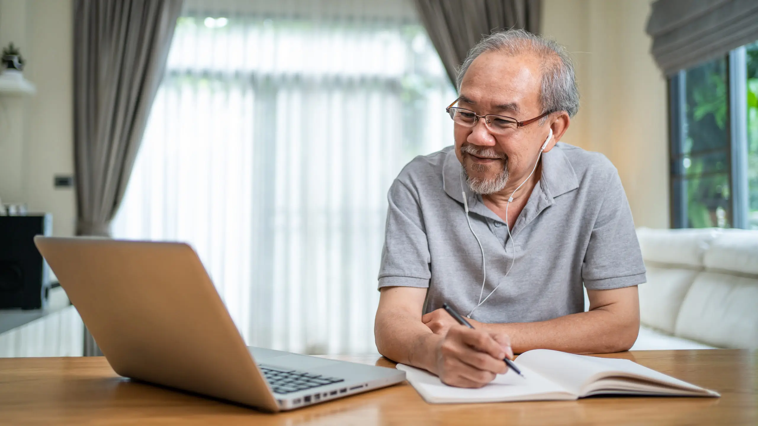 A senior man using his laptop